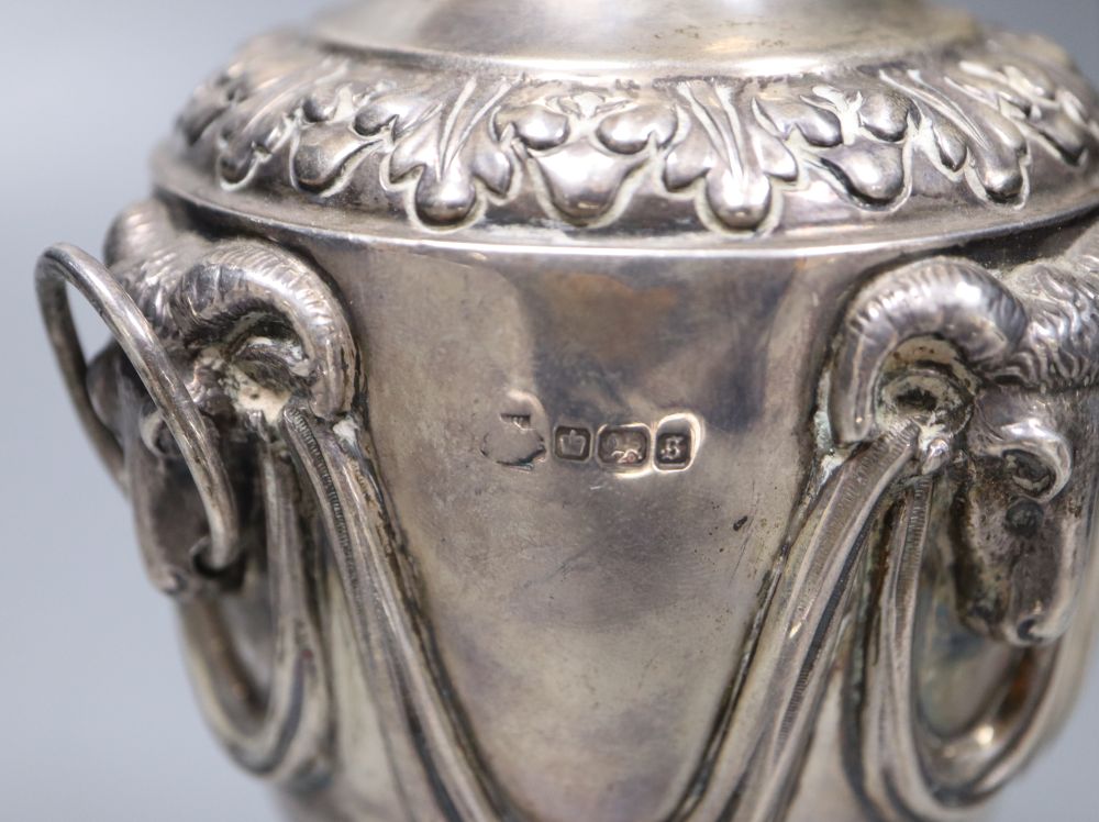 A George V silver vase and cover, with rams head and swag decoration and two ring handles, William Hutton & Sons, Sheffield, 1910,